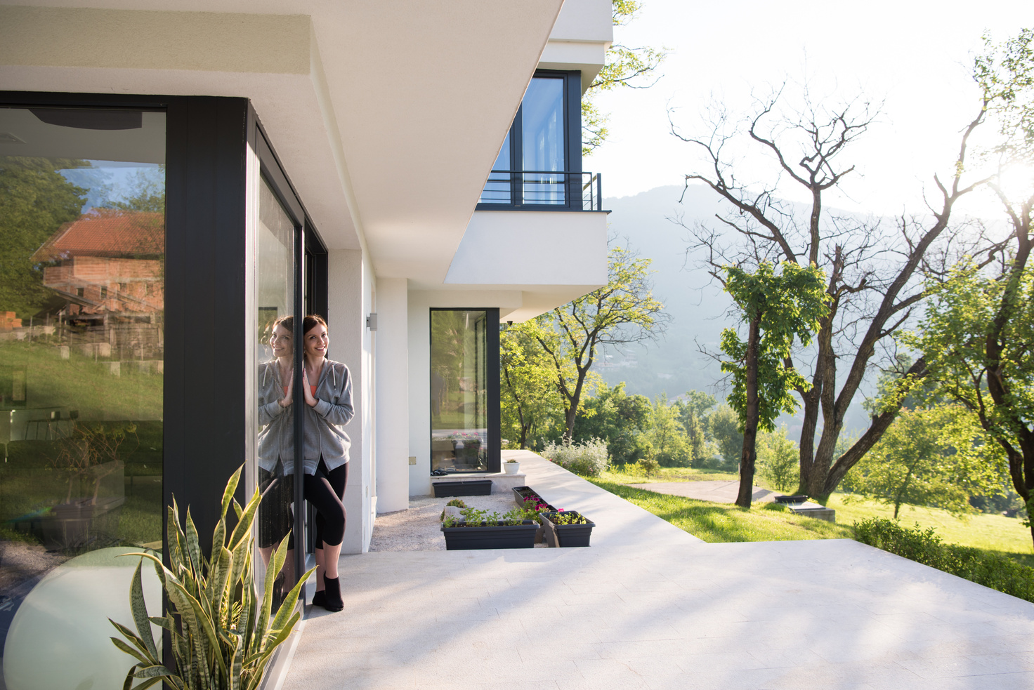 Woman in Front of Her Luxury Home Villa