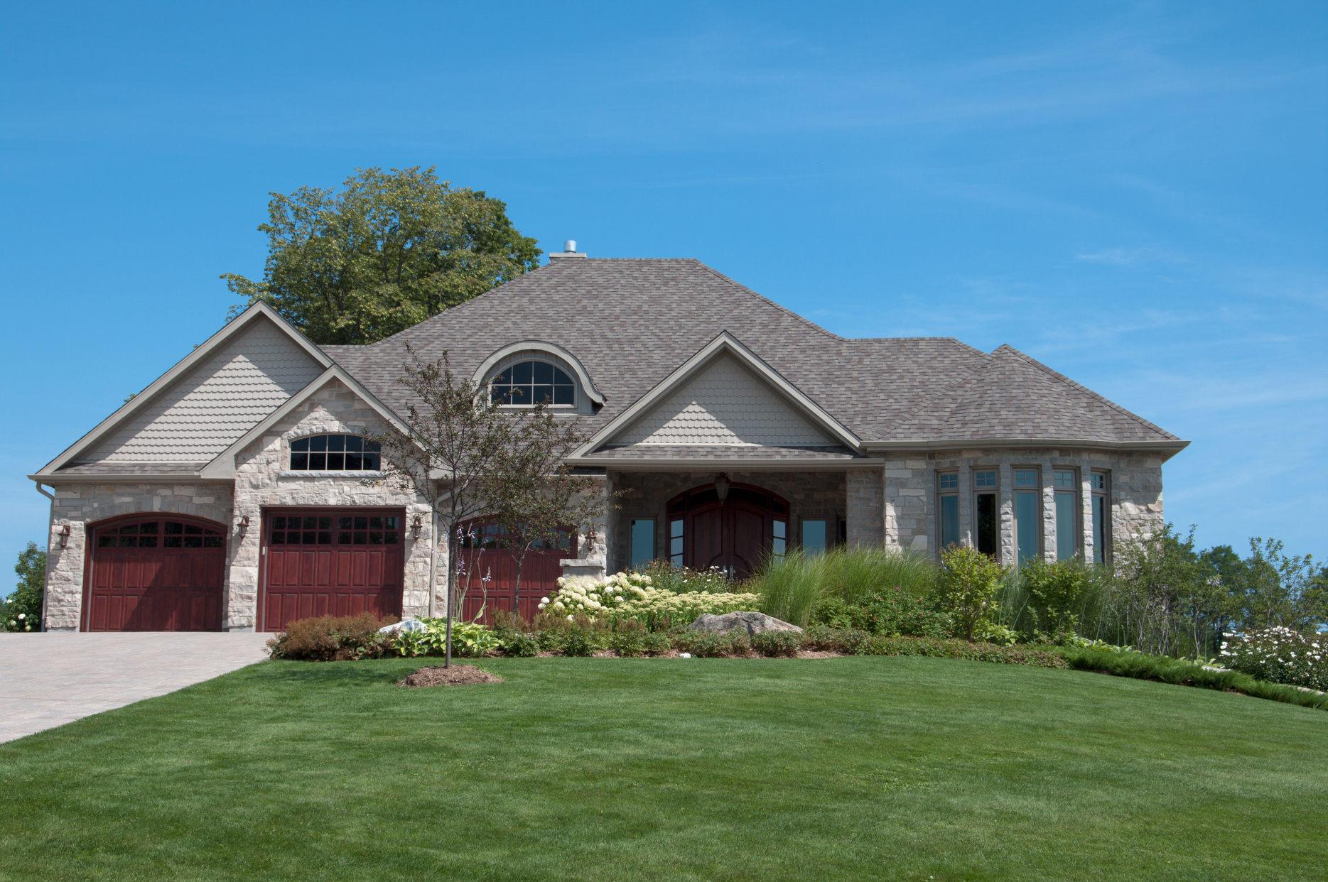 An executive home with front lawn on a sunny day